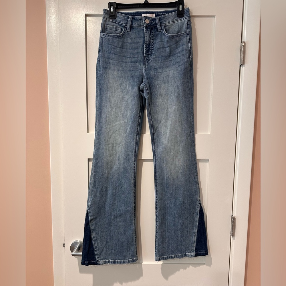 Jen 7 size 2 high rise light wash flare jeans with raw hem and panel.